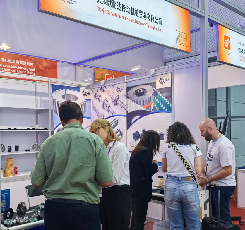 Visitors discussing transmission parts at the TJOND booth