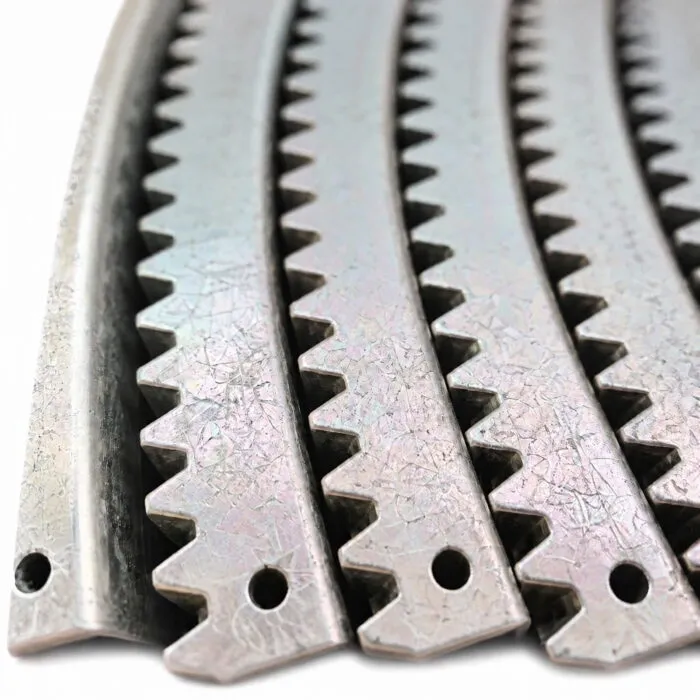 Close-up of curved gear rack teeth and end mounting holes on white background