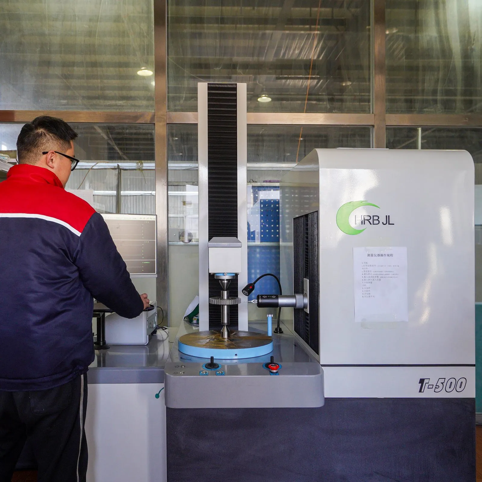 Inspector measuring a spur gear on a gear measuring centre